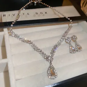 Silver V-shape fringe jewelry set with pear-shaped water drop pendants and sparkling rhinestones