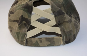 Close-up of camouflage ponytail baseball cap featuring elastic criss-cross back straps
