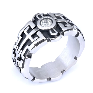 Close-up of retro stainless steel Masonic ring with black gemstone and intricate cut-out patterns