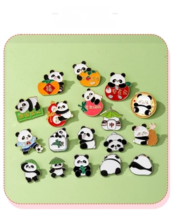 Macro view of eighteen diverse cartoon panda enamel pins on a light green background