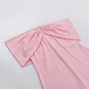 Close-up of pink off-shoulder dress with sparkling silver rhinestones on elastic fabric