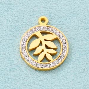 Detail view of a gold-plated circular pendant with leaf cutouts and clear crystals