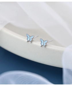 Macro shot of S925 sterling silver blue butterfly earrings with enamel finish