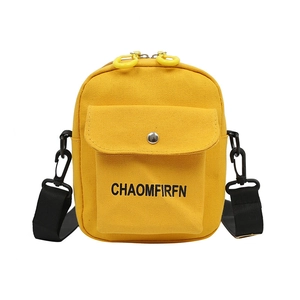 Minimalist bright yellow canvas crossbody bag with adjustable black shoulder strap and text