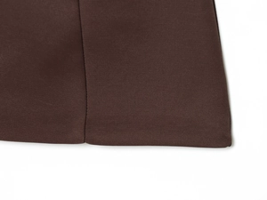Close-up of the dark brown twill fabric with detailed stitching on the short dress