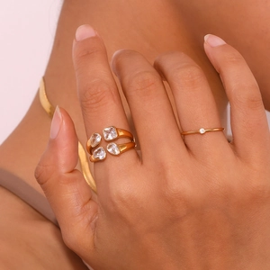 Detail of 18K gold plated double layer ring featuring four white teardrop zircons