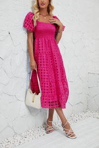 Detail of smocked bodice and tiered skirt on a rose pink summer midi dress
