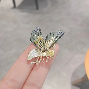 Back view of gold bee brooch showing secure butterfly clasp and hollow metal craftsmanship