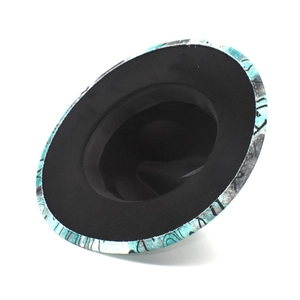 Detail of wide brim wool fedora featuring unique blue marble ink patterns on the edge