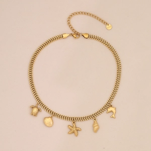 Detail of gold stainless steel marine necklace with turtle, shell and starfish charms