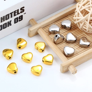 Polished hollow heart charms in gold and silver finish with side holes for DIY jewelry