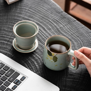 Ceramic tea mug with hand-painted rabbit and ice-crack glaze finish on wooden desk