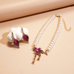 Detail of vintage flower pendant necklace with faux pearls and rhinestones
