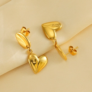 Gold-plated stainless steel heart earrings featuring engraved LOVE charms on satin