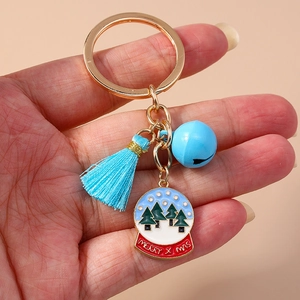 Detailed shot of Christmas keychain with blue bell, tassel and Merry X-mas enamel globe