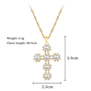 Detailed view of gold titanium cross necklace with pearls and crystal accents