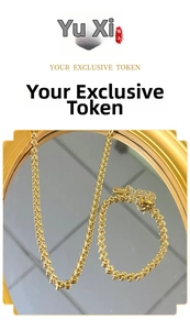 Close-up of 18k gold plated stainless steel woven chain necklace and bracelet set