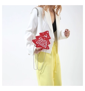 Detail of red Christmas tree crossbody bag with reindeer print and silver chain strap