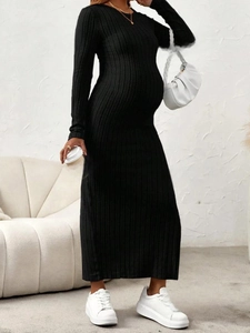 Slim fit black maternity knit dress with side slit and round neck for a stylish pregnancy