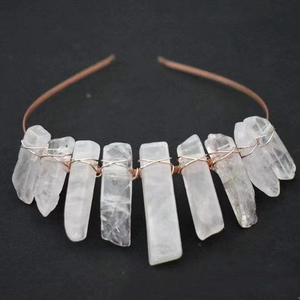 Close-up of raw rose quartz crystals hand-wired onto a headband with bronze metal wire