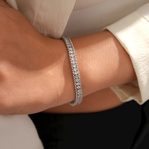Close-up of double-row tennis bracelet with sparkling zircon stones and metallic details