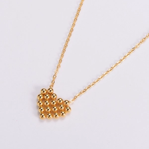 Golden heart pendant necklace with woven bead texture on a minimalist titanium steel chain