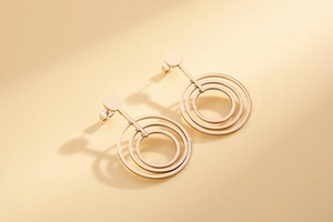 Macro view of triple concentric circle earrings in rose gold finish stainless steel