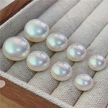 Close-up of premium iridescent white oversized pearls in a wooden jewelry display tray
