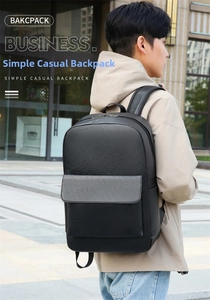 Side view of a black faux leather business backpack worn by a model in a city setting