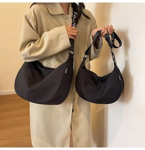 Size comparison of large and small black waterproof nylon crescent crossbody bags
