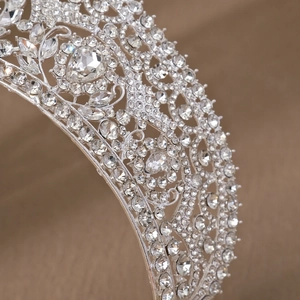 Close-up of sparkling silver rhinestones and intricate hollow patterns on a bridal crown