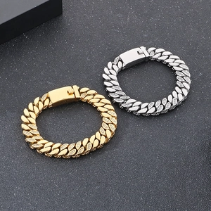 Detailed view of 12mm gold and silver iced out cuban chain bracelets with box clasps