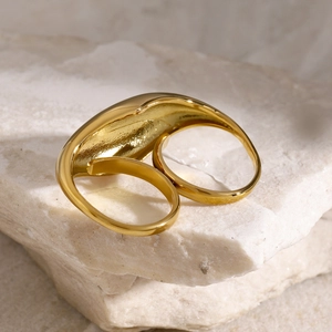 Close-up of a double-finger gold ring with a polished organic sculptural design