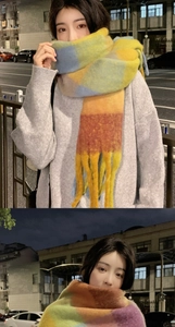 Close-up of soft mohair rainbow plaid scarf with decorative tassels in street style scene