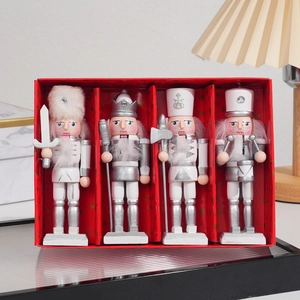 Set of four silver and white wooden nutcracker soldiers in a festive red gift box
