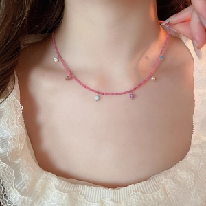 Detail of colorful crystal bead necklace with multi-color stone pendants on a model