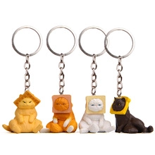 Detailed view of four 3D plastic cartoon cat keychains with bread slice headgear