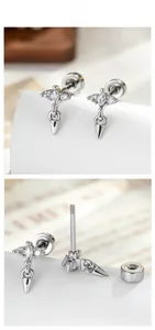 Macro detail of screw-back steel cartilage stud with cubic zirconia and cone pendant