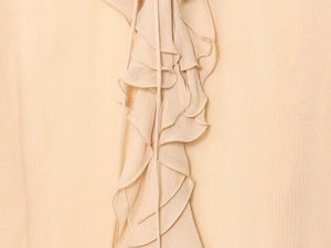 Detailed view of layered apricot ruffles with high-quality chiffon texture and craftsmanship