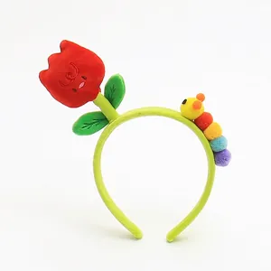 Detail of cute plush tulip and colorful caterpillar elements on a green floral headband