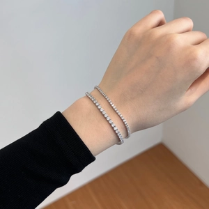 Detail of 925 sterling silver tennis bracelets with white cubic zirconia in layered style