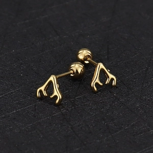 Macro detail of golden antler studs with secure screw-back ball closures for comfort