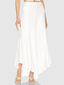 Detail of elegant white satin midi skirt featuring exquisite lace patchwork on the side