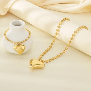 Golden stainless steel heart pendant necklace and beaded bracelet jewelry set for women