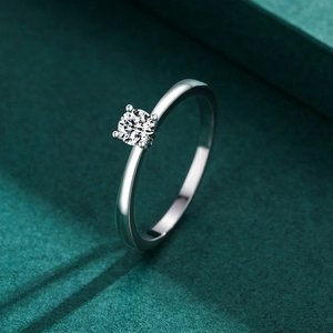 Classic S925 sterling silver four-prong ring with a brilliant round diamond on green velvet