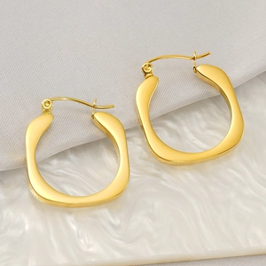 Detailed view of 18k gold plated stainless steel square U-shaped earrings on textured cloth