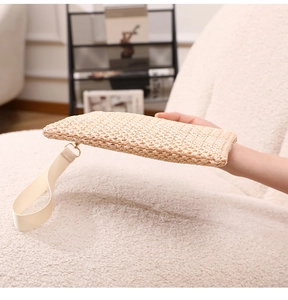 Detail of woven straw beach clutch with beige wristlet and golden metal ring