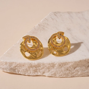 Golden irregular circle earrings with hammered texture and sparkling zircon crystals