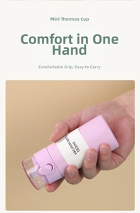 Detail of 150ml mini stainless steel vacuum bottle held in hand showing portable size