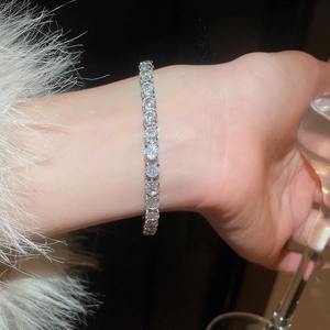 Close-up of sparkling zircon tennis bracelet with silver-tone four-prong setting for women